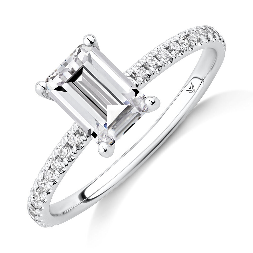 Engagement Ring with 1.14 Carat TW of Diamonds. A 1 Carat Emerald Cut Centre Laboratory Grown Diamond and shouldered by 0.14 Carat TW of Natural